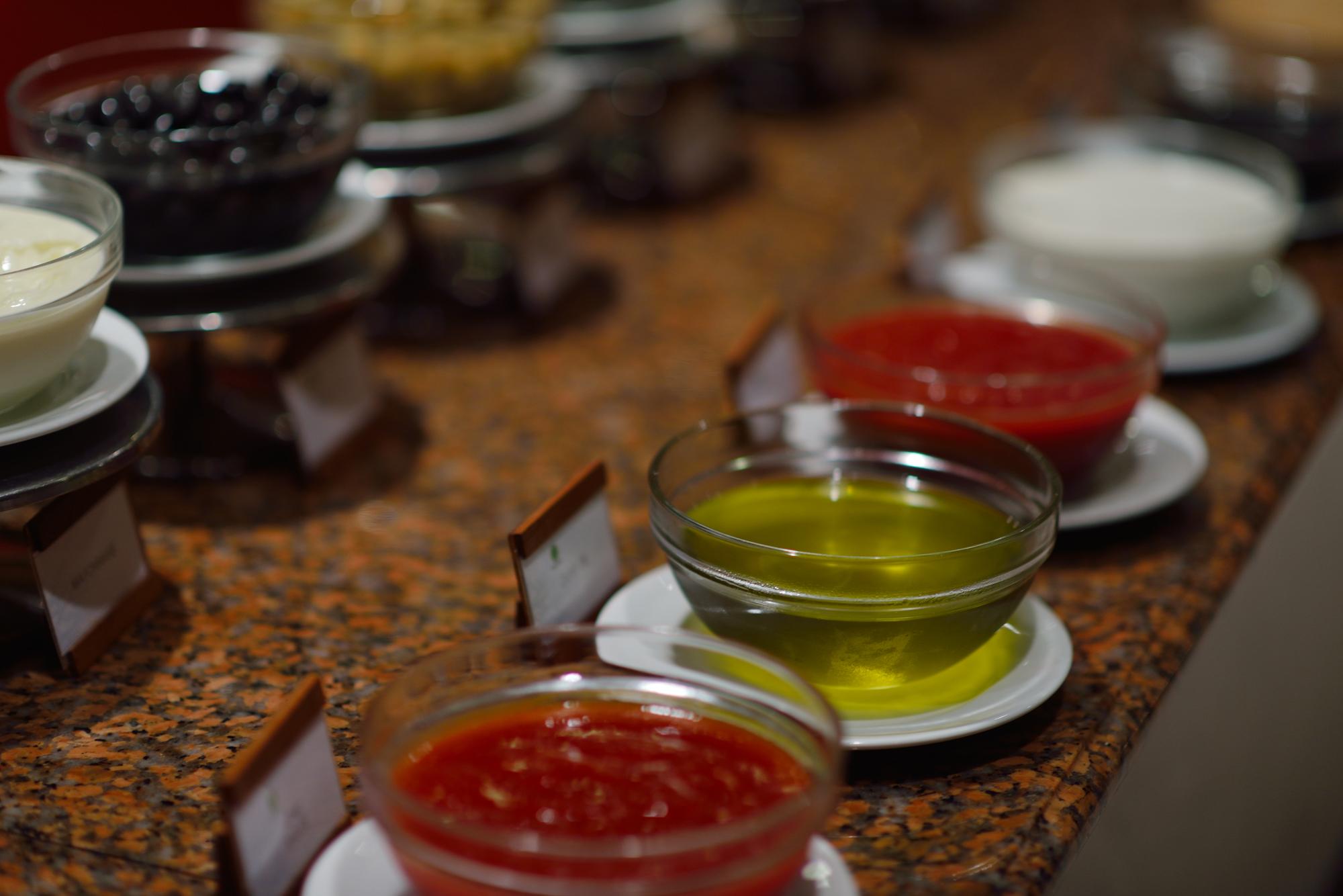 Group around table tasting sauces